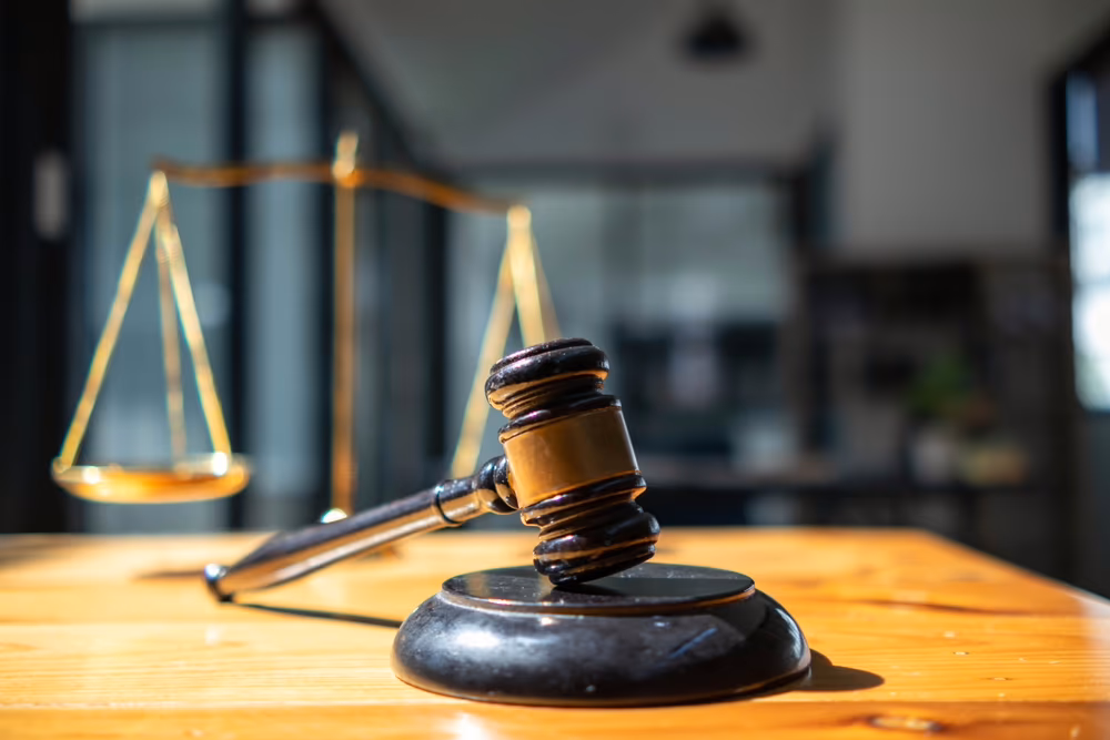 A wooden gavel resting on a table, a symbol of justice